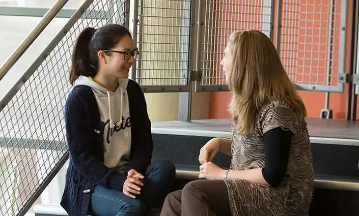 student support meeting on stairs